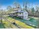 View of the house with a stone foundation and a deck overlooking the spacious backyard at 8445 Vernon Grove Rd, Chattahoochee Hills, GA 30268