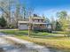 Charming two-story home on a large lot with mature trees and covered deck at 8445 Vernon Grove Rd, Chattahoochee Hills, GA 30268