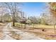 A view of the home's exterior highlighting the long private driveway and well-maintained yard at 8445 Vernon Grove Rd, Chattahoochee Hills, GA 30268