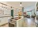 Open-concept kitchen featuring stainless steel appliances, concrete countertops and a stone accent wall at 8445 Vernon Grove Rd, Chattahoochee Hills, GA 30268