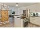 Well-equipped kitchen with stainless steel appliances and a unique stone accent wall with wooden door at 8445 Vernon Grove Rd, Chattahoochee Hills, GA 30268