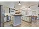 Modern eat-in kitchen boasts white cabinets and a stylish island at 8445 Vernon Grove Rd, Chattahoochee Hills, GA 30268