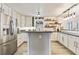 Spacious kitchen with stainless steel appliances, white cabinets, and a central island with concrete countertop at 8445 Vernon Grove Rd, Chattahoochee Hills, GA 30268