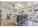 Spacious kitchen with modern appliances, white cabinets, and a bar area at 8445 Vernon Grove Rd, Chattahoochee Hills, GA 30268