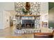 Stunning stone fireplace and hearth between the kitchen and living room at 8445 Vernon Grove Rd, Chattahoochee Hills, GA 30268