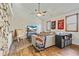 Cozy living room with wood-look flooring, ceiling fan, comfortable seating and natural light from two windows at 8445 Vernon Grove Rd, Chattahoochee Hills, GA 30268
