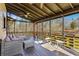 Relaxing screened-in porch with comfortable seating, perfect for enjoying the outdoors at 8445 Vernon Grove Rd, Chattahoochee Hills, GA 30268