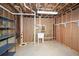 Unfinished basement with exposed framing, storage shelves, and utility sink for future customization at 110 Mountain Laurel Ct, Canton, GA 30114