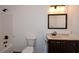 Bright bathroom featuring a vanity with a dark wood cabinet and tub with shower at 110 Mountain Laurel Ct, Canton, GA 30114