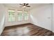 Sunlit bedroom features hardwood floors, a ceiling fan, and plantation shutters at 110 Mountain Laurel Ct, Canton, GA 30114
