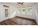 Bedroom boasts hardwood floors, a ceiling fan, plantation shutters, and a private access door at 110 Mountain Laurel Ct, Canton, GA 30114