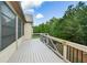 Outdoor wooden deck overlooks a treed, landscaped backyard at 110 Mountain Laurel Ct, Canton, GA 30114