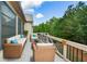 An outdoor deck offers comfortable seating with a view of the wooded landscape at 110 Mountain Laurel Ct, Canton, GA 30114