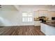 A cozy kitchen boasts hardwood floors, a large window with plantation shutters, and sleek countertops at 110 Mountain Laurel Ct, Canton, GA 30114
