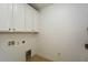 Clean laundry area features white cabinetry, neutral tiling, and updated utility connections at 110 Mountain Laurel Ct, Canton, GA 30114