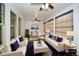 Sunroom features a cozy living area with elegant furniture and an adjacent dining space at 110 Mountain Laurel Ct, Canton, GA 30114