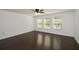 Finished living space with hardwood flooring, modern lighting, and multiple windows at 110 Mountain Laurel Ct, Canton, GA 30114