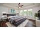 A modern main bedroom features a tray ceiling, plush carpets, and abundant natural light at 110 Mountain Laurel Ct, Canton, GA 30114