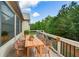 A backyard deck features wood furniture, scenic views, and abundant natural light at 110 Mountain Laurel Ct, Canton, GA 30114