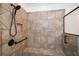 The walk-in shower features elegant tile design and a hand-held shower head at 110 Mountain Laurel Ct, Canton, GA 30114