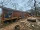 The backyard shows a brick house with a patio and various scattered items at 111 Oak Grove Rd, Temple, GA 30179