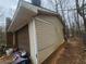 View of the side of a house with mixed siding and a garage at 111 Oak Grove Rd, Temple, GA 30179