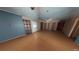 Spacious living room with wood-look floors, neutral walls, and multiple doorways, defurnished using Matterport AI at 111 Oak Grove Rd, Temple, GA 30179