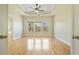 Spacious bedroom with hardwood floors, tray ceiling, ceiling fan, and large windows at 2782 Laurel Valley Trl, Buford, GA 30519