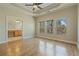 Spacious bedroom with hardwood floors, tray ceiling, ceiling fan, and large windows at 2782 Laurel Valley Trl, Buford, GA 30519