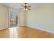 Spacious bedroom with hardwood floors, ceiling fan, and sliding glass door at 2782 Laurel Valley Trl, Buford, GA 30519