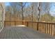Spacious outdoor deck with wood railing and beautiful wooded view at 2782 Laurel Valley Trl, Buford, GA 30519