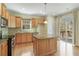 Bright kitchen features wood cabinets, stainless steel appliances, and a kitchen island at 2782 Laurel Valley Trl, Buford, GA 30519