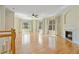 Open living room featuring gleaming hardwood floors and fireplace at 2782 Laurel Valley Trl, Buford, GA 30519