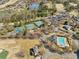Aerial showcases tennis courts, a pool, and a small lake adding to the community's recreational amenities at 6230 Hampton Highlands Dr, Cumming, GA 30041