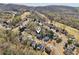 Aerial view showcases home nestled in a community surrounded by lush greenery and scenic neighborhood streets at 6230 Hampton Highlands Dr, Cumming, GA 30041