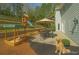 Spacious backyard with play set, sandbox, patio, and lush greenery at 6230 Hampton Highlands Dr, Cumming, GA 30041