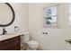 Powder room featuring a vanity with bronze fixtures and a framed mirror at 6230 Hampton Highlands Dr, Cumming, GA 30041