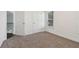 An empty bedroom features neutral carpet and large windows for natural light at 6230 Hampton Highlands Dr, Cumming, GA 30041