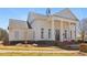 Exterior view of a clubhouse with pillars and a well-manicured lawn at 6230 Hampton Highlands Dr, Cumming, GA 30041