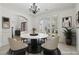 Bright dining room featuring a modern chandelier, large windows, and a stylish marble table at 6230 Hampton Highlands Dr, Cumming, GA 30041