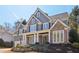 Charming two-story home with stone accents, a covered entryway, well-manicured landscaping and beautiful curb appeal at 6230 Hampton Highlands Dr, Cumming, GA 30041