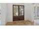 Inviting foyer with beautiful tile flooring and a view of the home's exterior through the front doors at 6230 Hampton Highlands Dr, Cumming, GA 30041
