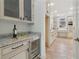 Convenient butler's pantry area with a wine cooler, granite countertop, and additional storage at 6230 Hampton Highlands Dr, Cumming, GA 30041