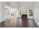 Open-concept living room boasts hardwood floors, a stone fireplace, and natural light at 6230 Hampton Highlands Dr, Cumming, GA 30041