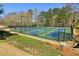 Multiple tennis courts are available in this community, with lighting, and green spaces around them at 6230 Hampton Highlands Dr, Cumming, GA 30041