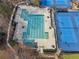 Aerial view showing pool, lounge chairs, tennis courts, and beautifully landscaped grounds at 708 Larkspur Nw Blvd, Acworth, GA 30102