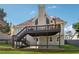 Backyard view with a large deck, patio, and well-maintained lawn at 708 Larkspur Nw Blvd, Acworth, GA 30102