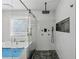 Modern bathroom with a sleek walk-in shower, separate soaking tub and mosaic tile floor at 708 Larkspur Nw Blvd, Acworth, GA 30102