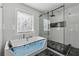 Bright bathroom featuring a soaking tub, frameless shower, and modern fixtures at 708 Larkspur Nw Blvd, Acworth, GA 30102