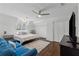 Bright bedroom features hardwood floors, a ceiling fan, and a comfortable blue sofa at 708 Larkspur Nw Blvd, Acworth, GA 30102